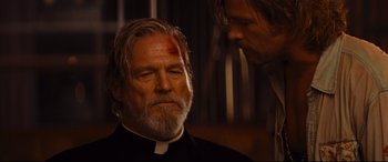 Movie still from “Bad Times at the El Royale” (2018), directed by Drew Goddard – A man in a priest's outfit with a bandage on his head; Close Up shot, Over the shoulder angle