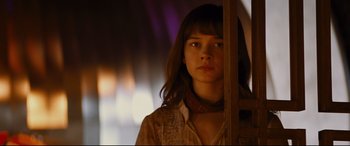Movie still from “Bad Times at the El Royale” (2018), directed by Drew Goddard – A woman standing in front of a wooden wall; Close Up shot, Low angle