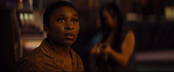 Movie still from “Bad Times at the El Royale” (2018), directed by Drew Goddard – A woman stares into the distance while another woman stands in the background; Close Up shot, Over the shoulder angle