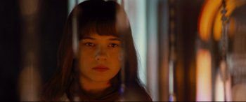 Movie still from “Bad Times at the El Royale” (2018), directed by Drew Goddard – A young woman with long hair is looking at the camera through a window; Close Up shot, Over the shoulder angle