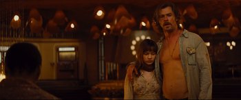 Movie still from “Bad Times at the El Royale” (2018), directed by Drew Goddard – A man and a woman standing next to each other in a room; Medium shot, Low angle