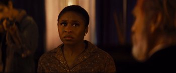 Movie still from “Bad Times at the El Royale” (2018), directed by Drew Goddard – A woman in a brown shirt looking at the camera; Close Up shot, Over the shoulder angle