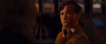 Movie still from “Bad Times at the El Royale” (2018), directed by Drew Goddard – A young man with blood all over his face; Close Up shot, High angle