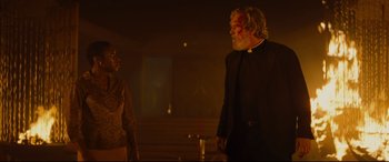 Movie still from “Bad Times at the El Royale” (2018), directed by Drew Goddard – A man and a woman standing next to each other in a dark room; Medium shot, Low angle
