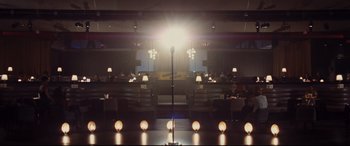 Movie still from “Bad Times at the El Royale” (2018), directed by Drew Goddard – A microphone in the middle of an empty room; Extreme Wide shot, High angle