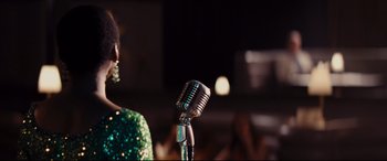 Movie still from “Bad Times at the El Royale” (2018), directed by Drew Goddard – A microphone on a microphone stand; Close Up shot, Over the shoulder angle