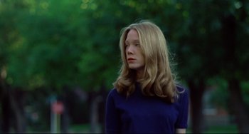 Movie still from “Badlands” (1973), directed by Terrence Malick – A woman with long blonde hair standing in a park; Medium shot, Low angle