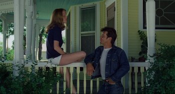 Movie still from “Badlands” (1973), directed by Terrence Malick – A man and a woman sitting on a porch; Medium shot, Low angle