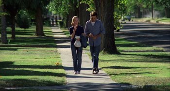 Movie still from “Badlands” (1973), directed by Terrence Malick – A man and a woman walking down a sidewalk; Wide shot, Low angle