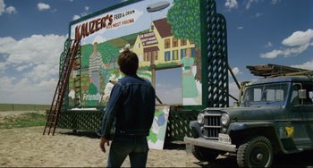 Movie still from “Badlands” (1973), directed by Terrence Malick – A man standing in front of a food truck; Wide shot, Low angle