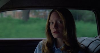 Movie still from “Badlands” (1973), directed by Terrence Malick – A woman sitting in the back seat of a car; Close Up shot, Low angle