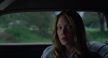 Movie still from “Badlands” (1973), directed by Terrence Malick – A woman sitting in the back seat of a car; Close Up shot, Low angle