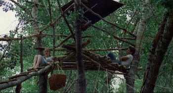 Movie still from “Badlands” (1973), directed by Terrence Malick – A group of people sitting in a tree house; Wide shot, Low angle