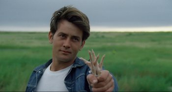 Movie still from “Badlands” (1973), directed by Terrence Malick – A young man holding something in his hand; Close Up shot, Over the shoulder angle
