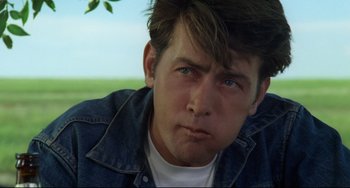 Movie still from “Badlands” (1973), directed by Terrence Malick – A person wearing a jean jacket; Close Up shot, Over the shoulder angle