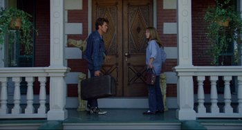 Movie still from “Badlands” (1973), directed by Terrence Malick – A man and a woman standing in front of a door; Wide shot, Low angle