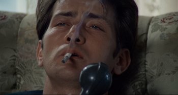 Movie still from “Badlands” (1973), directed by Terrence Malick – A person smoking a cigarette; Close Up shot, High angle