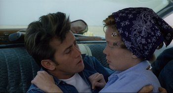 Movie still from “Badlands” (1973), directed by Terrence Malick – A man and a woman sitting in the back of a car; Close Up shot, Over the shoulder angle