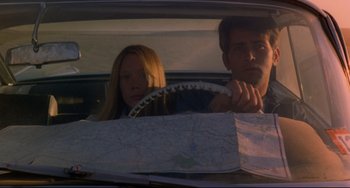 Movie still from “Badlands” (1973), directed by Terrence Malick – A man and a woman in the back seat of a car; Medium shot, High angle