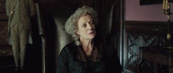 Movie still from “Becoming Jane” (2007), directed by Julian Jarrold – An older woman wearing a black dress and a black hat; Close Up shot, Low angle