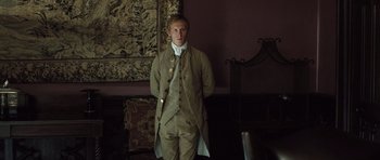 Movie still from “Becoming Jane” (2007), directed by Julian Jarrold – A man standing in front of a wall; Medium shot, Low angle