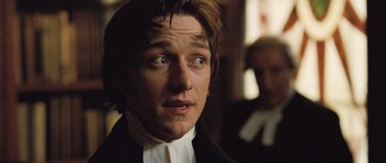Movie still from “Becoming Jane” (2007), directed by Julian Jarrold – A person wearing a suit and tie; Close Up shot, Over the shoulder angle