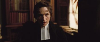 Movie still from “Becoming Jane” (2007), directed by Julian Jarrold – A man wearing a black jacket and a white shirt; Close Up shot, Over the shoulder angle