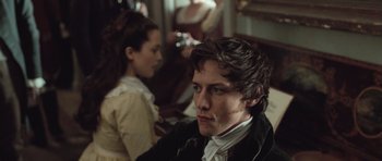 Movie still from “Becoming Jane” (2007), directed by Julian Jarrold – A young man and a young woman are sitting in a room together; Close Up shot, Over the shoulder angle