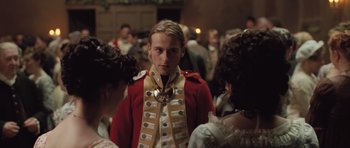Movie still from “Becoming Jane” (2007), directed by Julian Jarrold – A man in a red coat and a medal around his neck; Close Up shot, Over the shoulder angle