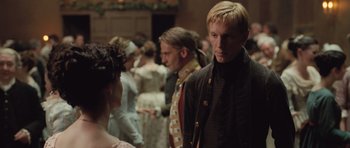 Movie still from “Becoming Jane” (2007), directed by Julian Jarrold – A group of people standing in a room; Medium shot, Over the shoulder angle