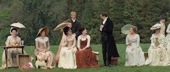 Movie still from “Becoming Jane” (2007), directed by Julian Jarrold – A group of people sitting on the grass talking to each other; Wide shot, High angle