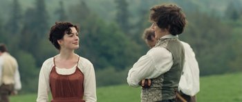 Movie still from “Becoming Jane” (2007), directed by Julian Jarrold – A man and a woman standing next to each other in a field; Medium shot, Over the shoulder angle