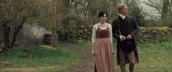 Movie still from “Becoming Jane” (2007), directed by Julian Jarrold – A man and a woman standing next to each other on a dirt path; Medium shot, Over the shoulder angle