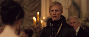 Movie still from “Becoming Jane” (2007), directed by Julian Jarrold – A man with blonde hair wearing a black jacket; Close Up shot, Over the shoulder angle