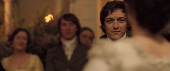 Movie still from “Becoming Jane” (2007), directed by Julian Jarrold – A man standing next to another man in a suit; Close Up shot, Over the shoulder angle