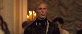 Movie still from “Becoming Jane” (2007), directed by Julian Jarrold – A man with blonde hair wearing a black jacket; Close Up shot, Over the shoulder angle