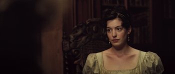 Movie still from “Becoming Jane” (2007), directed by Julian Jarrold – A beautiful woman sitting in a chair in a room; Close Up shot, Over the shoulder angle