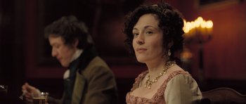 Movie still from “Becoming Jane” (2007), directed by Julian Jarrold – A woman with curly hair wearing a pink dress; Close Up shot, Over the shoulder angle