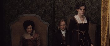 Movie still from “Becoming Jane” (2007), directed by Julian Jarrold – A group of people sitting in a room; Medium shot, High angle