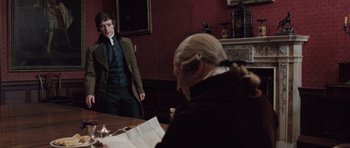 Movie still from “Becoming Jane” (2007), directed by Julian Jarrold – A man standing in front of another man in front of a table; Medium shot, Over the shoulder angle