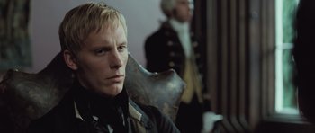 Movie still from “Becoming Jane” (2007), directed by Julian Jarrold – A man sitting in front of another man in a suit; Close Up shot, Over the shoulder angle