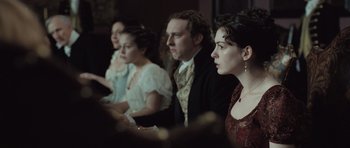 Movie still from “Becoming Jane” (2007), directed by Julian Jarrold – A group of people sitting next to each other in a room; Medium shot, High angle