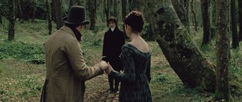 Movie still from “Becoming Jane” (2007), directed by Julian Jarrold – A man and a woman standing next to each other in the woods; Medium shot, Over the shoulder angle