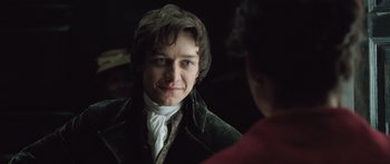 Movie still from “Becoming Jane” (2007), directed by Julian Jarrold – A man in a green jacket looking into a mirror; Close Up shot, Over the shoulder angle