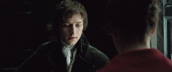 Movie still from “Becoming Jane” (2007), directed by Julian Jarrold – A young man in a green velvet jacket looking at his reflection in a mirror; Close Up shot, Over the shoulder angle