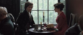Movie still from “Becoming Jane” (2007), directed by Julian Jarrold – A man and a woman sitting at a table; Medium shot, Over the shoulder angle