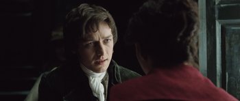 Movie still from “Becoming Jane” (2007), directed by Julian Jarrold – A man in a green jacket looking at another man in a red jacket; Close Up shot, Over the shoulder angle