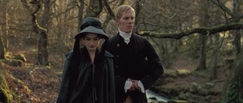 Movie still from “Becoming Jane” (2007), directed by Julian Jarrold – A man and a woman standing next to each other in the woods; Medium shot, Low angle