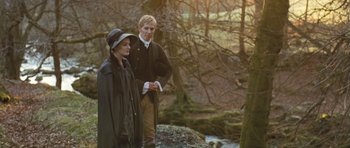 Movie still from “Becoming Jane” (2007), directed by Julian Jarrold – A man and a woman standing next to each other in the woods; Medium shot, Over the shoulder angle