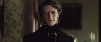 Movie still from “Becoming Jane” (2007), directed by Julian Jarrold – A person wearing a suit and tie; Close Up shot, Low angle